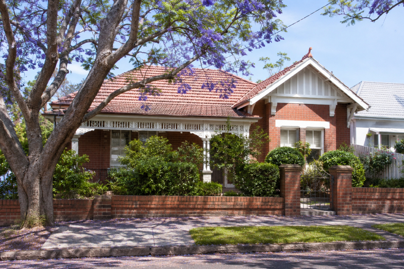 unpainted federation-era red brick home in a sydney suburb