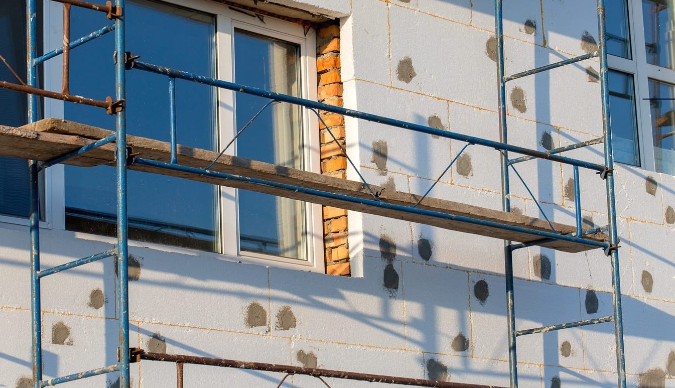 house for renovation with scaffolding for workers